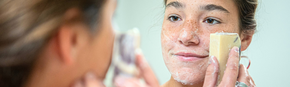 Jade washing her face with goat milk soap