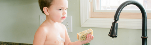 Landon holding a bar of goat milk soap