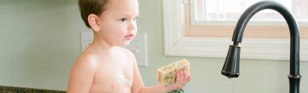 Landon holding a bar of goat milk soap