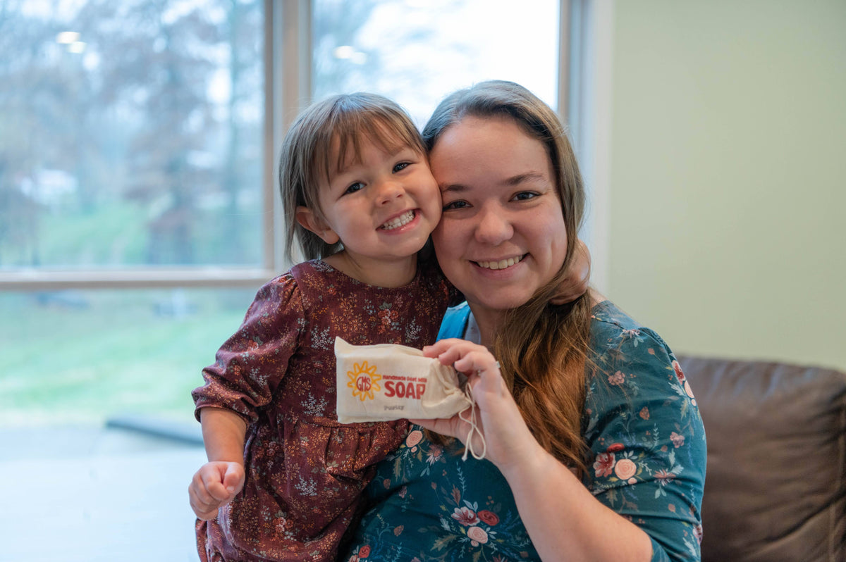 A mother and daughter holding Goat Milk Stuff soap together