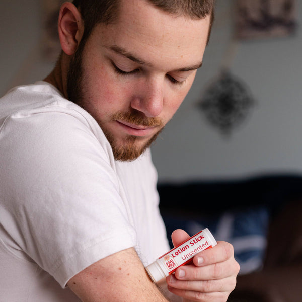 Man applying Goat Milk Stuff Small Lotion to his arm.