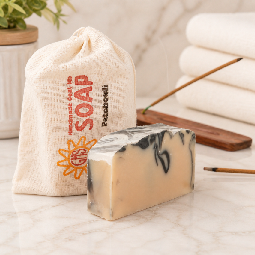 Marble-patterned goat milk soap bar with a drawstring bag labeled 'Soap' on a marble surface.