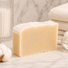 Bar of goat milk soap on a marble surface with a soft focus background