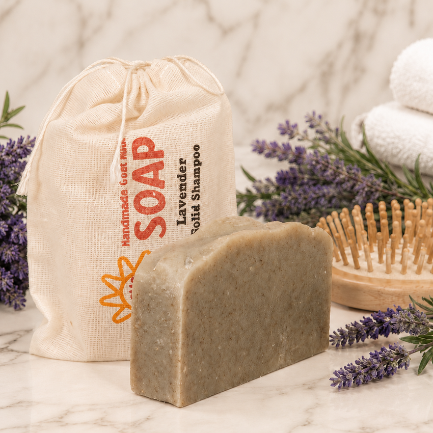 Bar of soap with a drawstring bag labeled 'Soap' and lavender flowers on a marble surface.