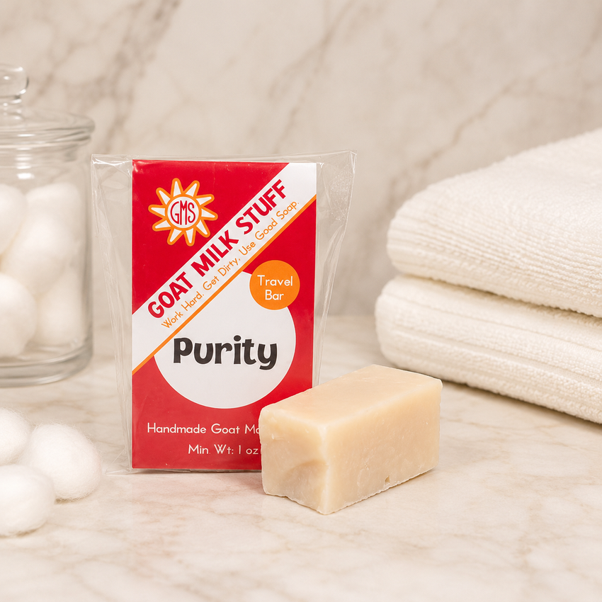 Bar of goat milk soap with a red packaging labeled 'Purity' on a neutral background.