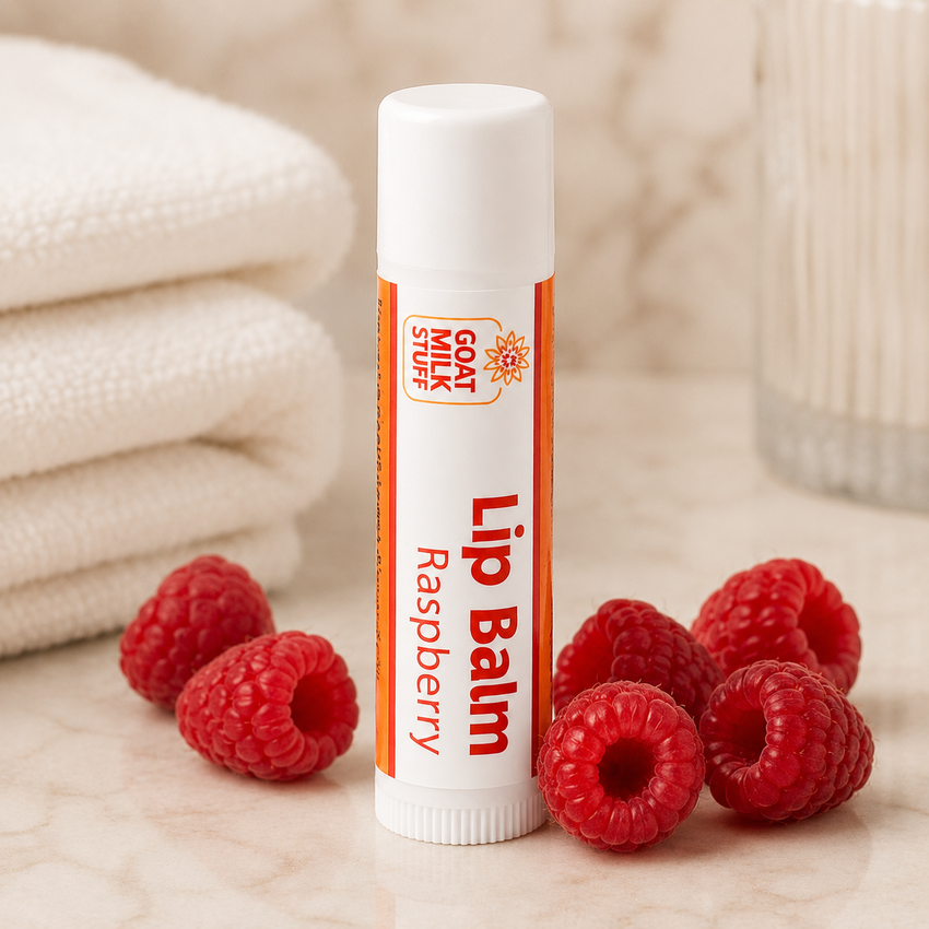 Lip balm with raspberry flavor on a wooden surface with raspberries and towels in the background