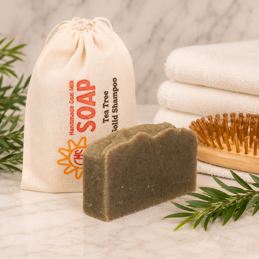 Bar of soap with a drawstring bag labeled 'Soap' and a wooden brush on a marble surface.