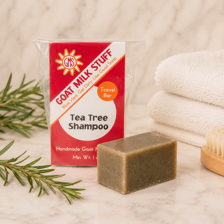 Goat Milk Stuff Tea Tree Shampoo bar with packaging on a neutral background