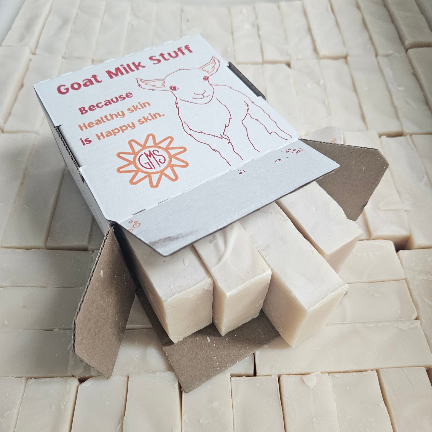 Four Purity goat milk soap bars in a Goat Milk Stuff box