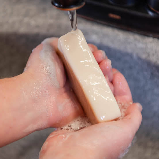 Washing hands with goat milk soap