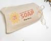 bar of goat milk soap in cotton bag for natural pet care