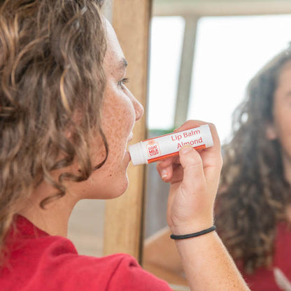 applying super goat milk lip balm